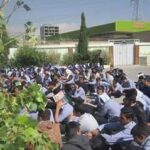 تجمع دانش‌آموزان در حیاط مدرسه برای یک مراسم یا گردهمایی گروهی