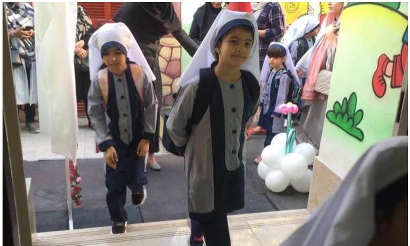 دانش‌آموزان دختر مدرسه در یک نمایشگاه تعلیمی با تزئینات و هنرآفرینی دستساخته، در حال حضور در یک فعالیت مدرسه‌ای