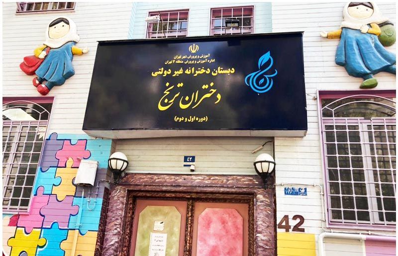 نمای بیرونی درب ورودی دبستان دخترانه درشرق با تابلوی مشکی و متن طلایی