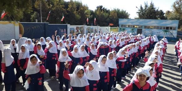 دانش‌آموزانی در صفوف ایستاده‌اند در حیاط مدرسه برای مراسم صبح‌گاهی