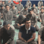 گروهی از دانش‌آموزان نشسته در کنار هم در حال شرکت در یک جلسه یا فعالیت گروهی درون مدرسه‌ای