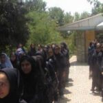 دانش‌آموزان در یک مراسم دسته‌جمعی درحیاط مدرسه