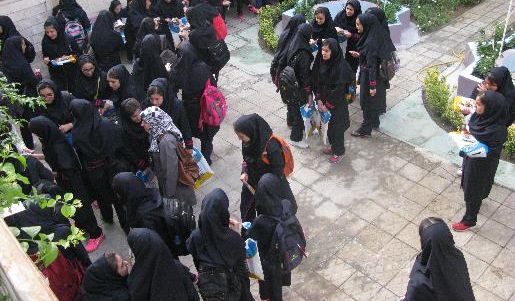 دانش‌آموزان سیاه‌پوش فرم شده در حیاط مدرسه برای شرکت در یک مراسم یا رویداد گروهی