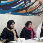 دانش‌آموزان دخترانه در حال انجام فعالیت تحقیقاتی گروهی در کلاس درس با استفاده از مواد و اسناد
